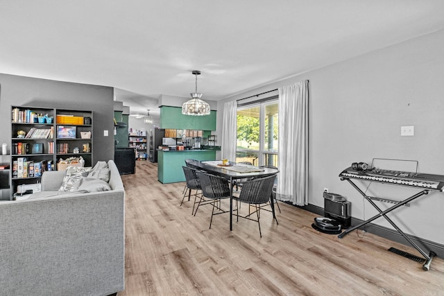 dining area featuring a chandelier and light hardwood / wood-style flooring