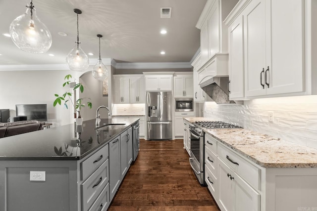 kitchen featuring stainless steel appliances, white cabinetry, and sink