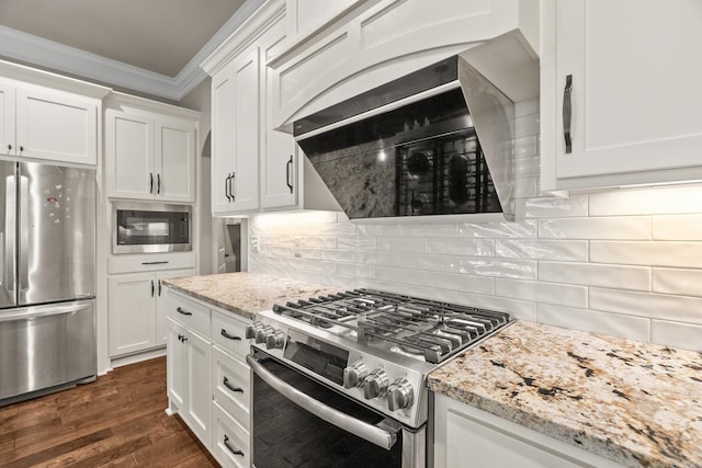 kitchen featuring light stone counters, white cabinetry, stainless steel appliances, and dark wood-type flooring