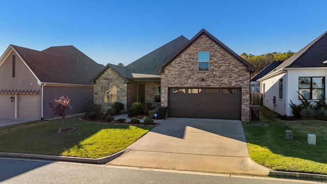 view of front facade with a garage and a front lawn