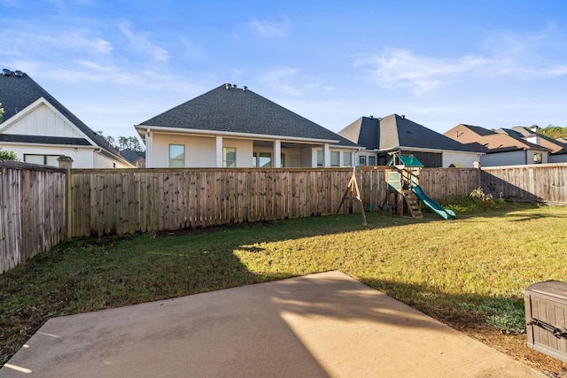 view of yard featuring a playground and a patio