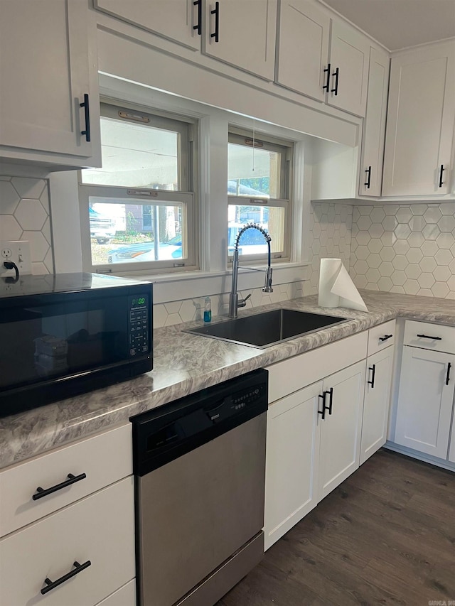 kitchen featuring backsplash, dark hardwood / wood-style flooring, white cabinets, and stainless steel dishwasher