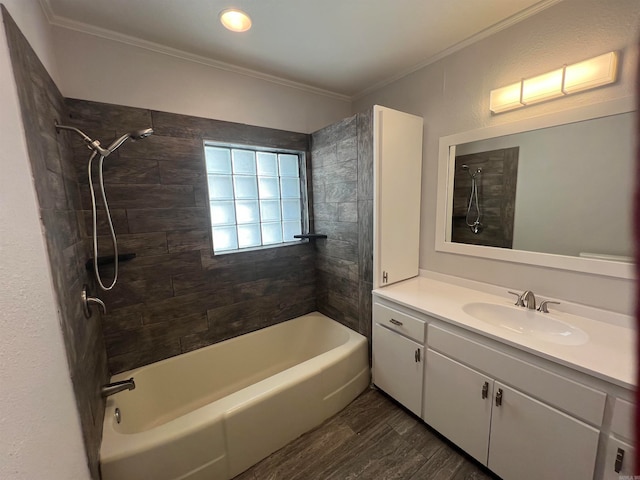 bathroom featuring crown molding, vanity, wood-type flooring, and tiled shower / bath