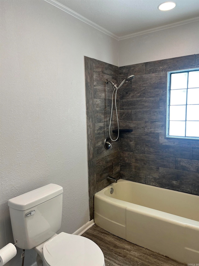 bathroom featuring toilet, ornamental molding, tiled shower / bath combo, and hardwood / wood-style flooring