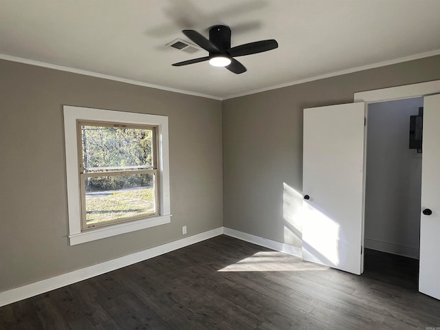 spare room with dark hardwood / wood-style floors, ceiling fan, and crown molding