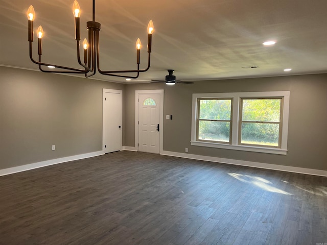 interior space with ceiling fan with notable chandelier and dark hardwood / wood-style flooring