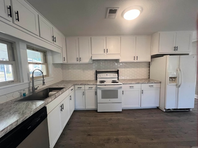 kitchen with white cabinets, white appliances, and sink