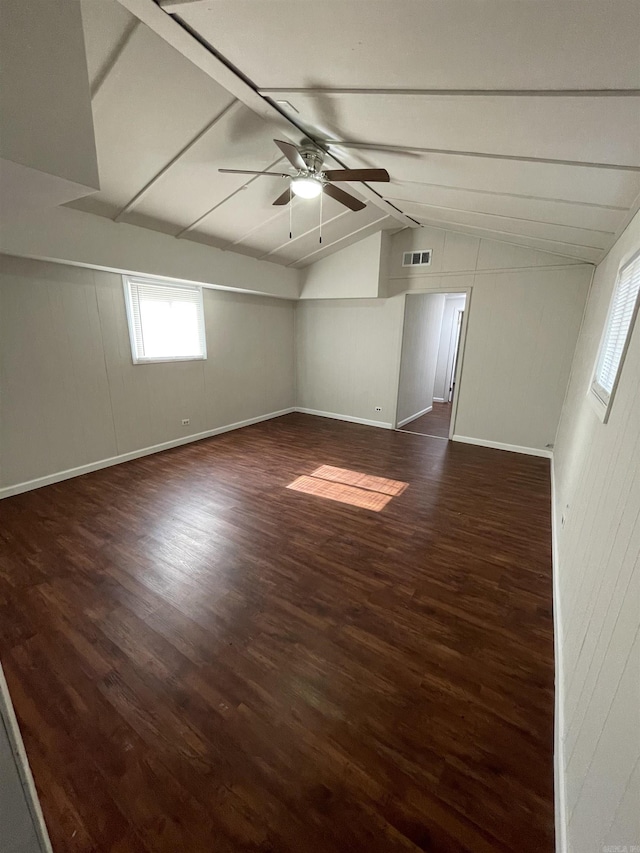 unfurnished room featuring ceiling fan, dark wood-type flooring, and vaulted ceiling