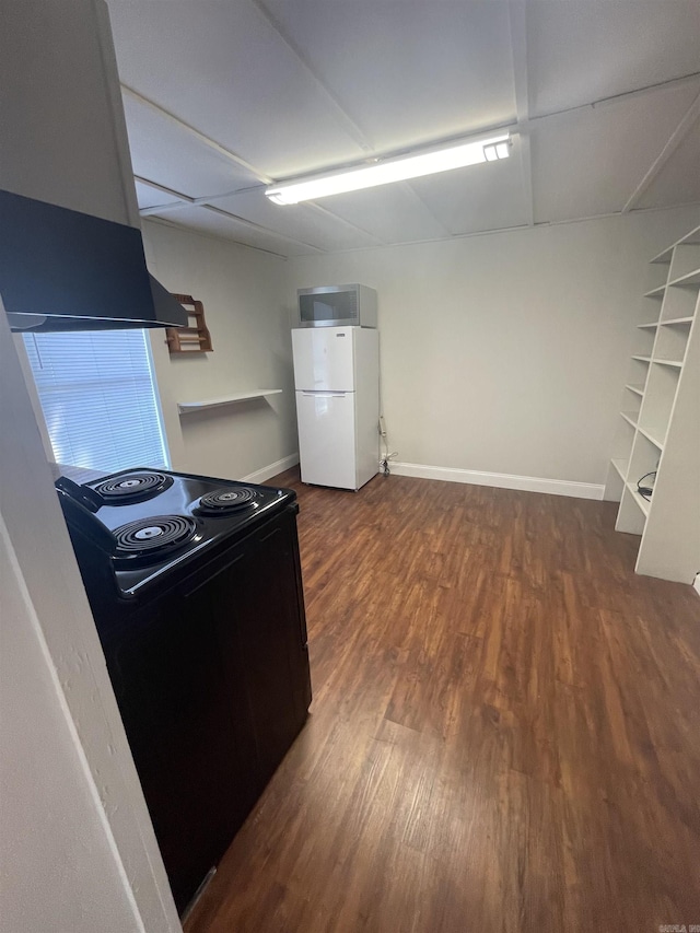 kitchen featuring dark hardwood / wood-style floors, white refrigerator, range hood, and black / electric stove