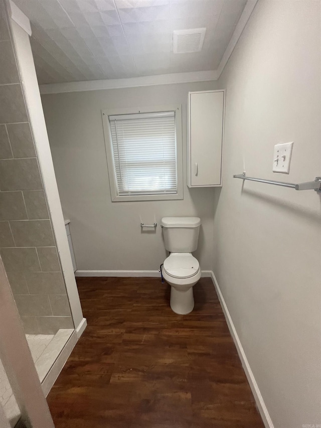 bathroom with walk in shower, toilet, hardwood / wood-style floors, and ornamental molding