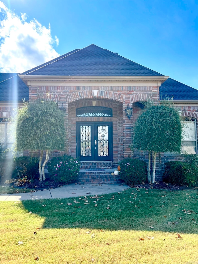 view of front of house featuring french doors and a front lawn