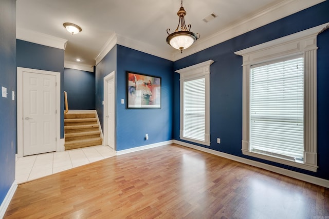 unfurnished room with hardwood / wood-style floors and crown molding