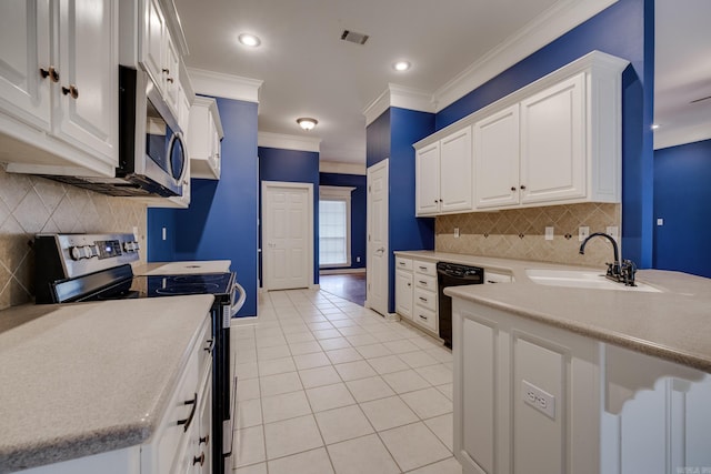 kitchen with appliances with stainless steel finishes, crown molding, sink, light tile patterned floors, and white cabinetry