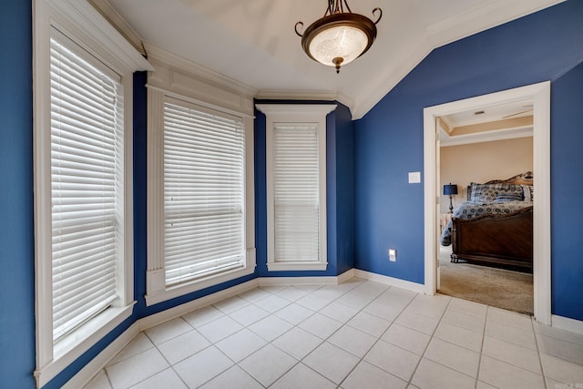 tiled empty room with lofted ceiling and ornamental molding