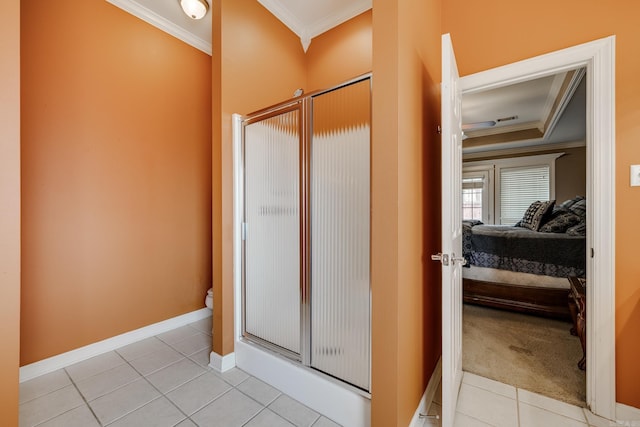 bathroom featuring tile patterned flooring, a shower with shower door, and ornamental molding