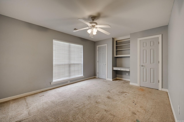 unfurnished bedroom with ceiling fan and light carpet