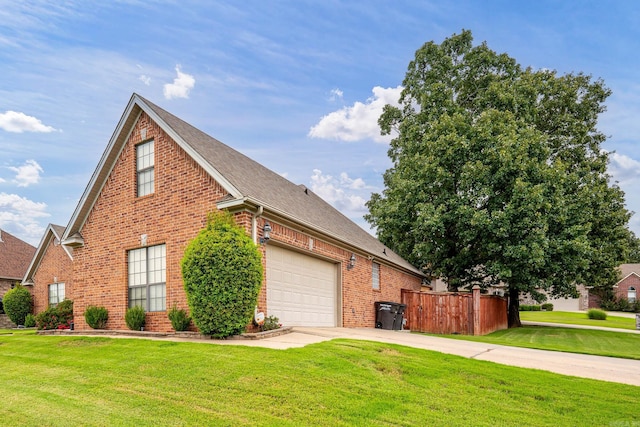 view of side of home featuring a garage and a yard