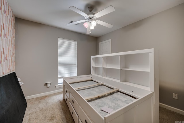 unfurnished bedroom featuring ceiling fan and light colored carpet