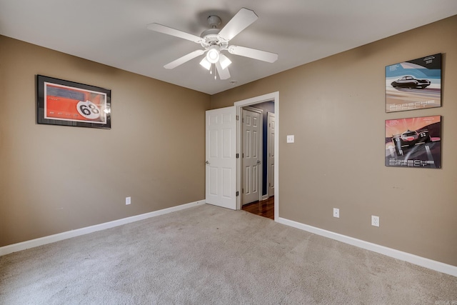 unfurnished room with carpet flooring and ceiling fan