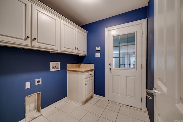 clothes washing area with hookup for a washing machine, light tile patterned floors, cabinets, and hookup for an electric dryer