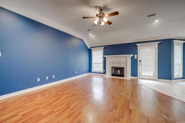 unfurnished living room with ceiling fan, light hardwood / wood-style flooring, vaulted ceiling, and ornamental molding