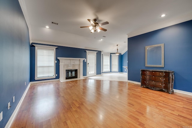 unfurnished living room featuring ceiling fan, light hardwood / wood-style floors, and crown molding