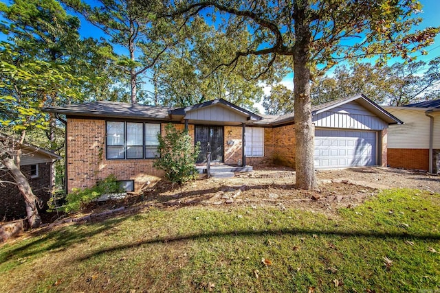 ranch-style house with a front yard and a garage