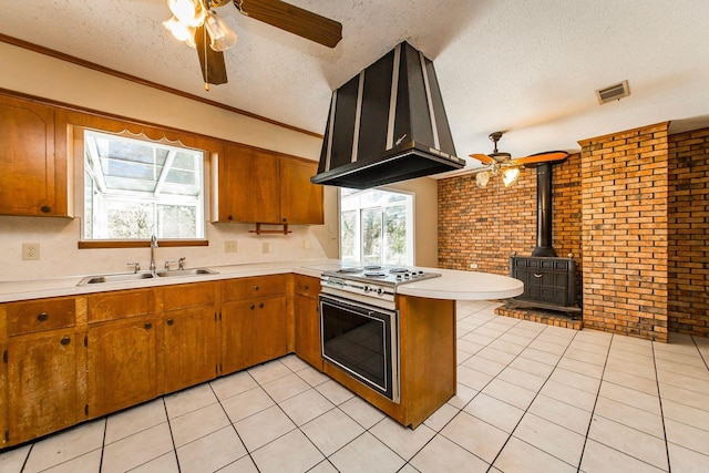 kitchen featuring brick wall, a textured ceiling, sink, and exhaust hood