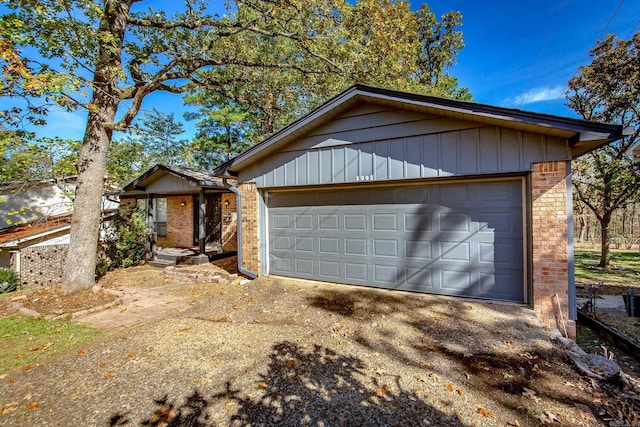 single story home featuring a garage and an outdoor structure