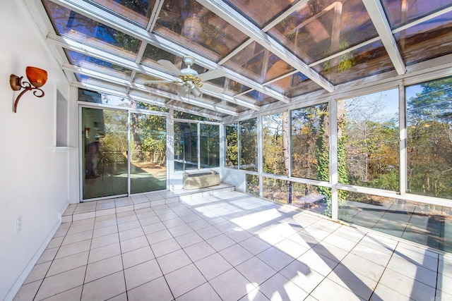 unfurnished sunroom with ceiling fan