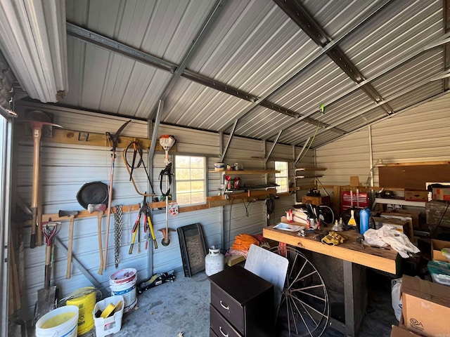 garage featuring a workshop area and wood walls