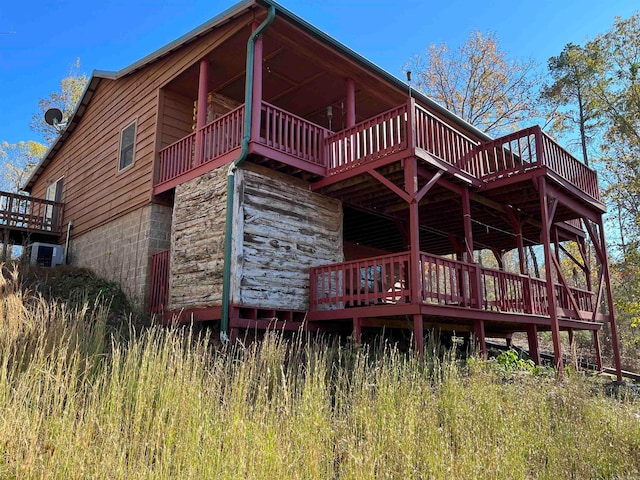 view of side of home featuring central AC