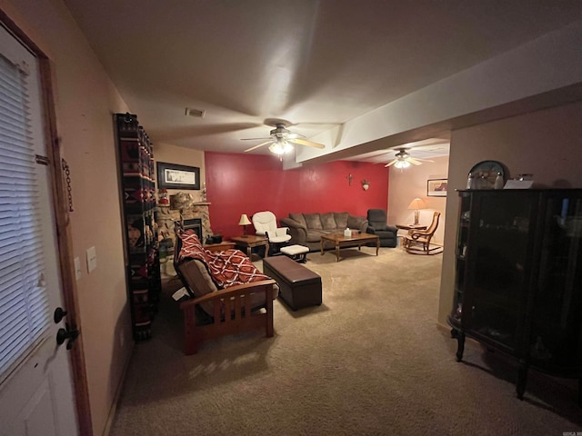 living room with carpet flooring, ceiling fan, and a fireplace