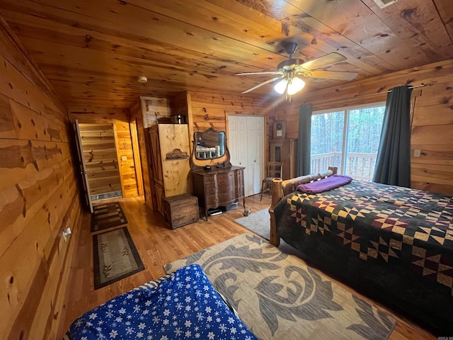 bedroom featuring wooden walls, ceiling fan, wood ceiling, and hardwood / wood-style flooring