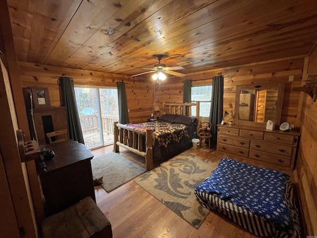 1217 Lovell Ln, Mountain View, AR 72560 - bedroom featuring access to outside, wood finished floors, wooden ceiling, wooden walls, and ceiling fan