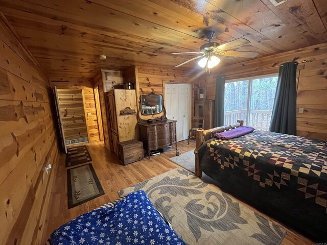 1217 Lovell Ln, Mountain View, AR 72560 - bedroom with wood ceiling, wood walls, light wood-type flooring, and a ceiling fan