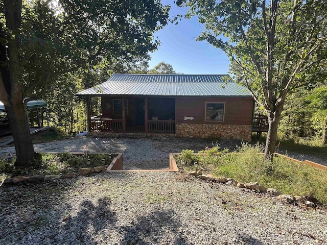 1217 Lovell Ln, Mountain View, AR 72560 - back of house featuring covered porch, stone siding, and metal roof