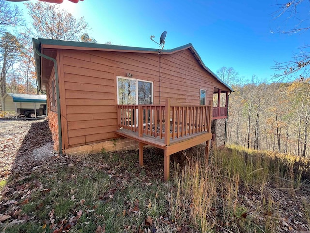 rear view of house featuring a wooden deck