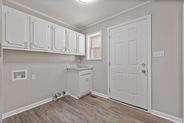 washroom with sink, cabinets, hookup for a washing machine, light wood-type flooring, and ornamental molding