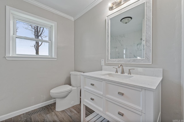 bathroom featuring hardwood / wood-style floors, vanity, toilet, and ornamental molding