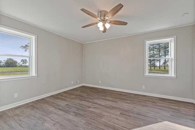 unfurnished room featuring hardwood / wood-style floors, ceiling fan, and ornamental molding