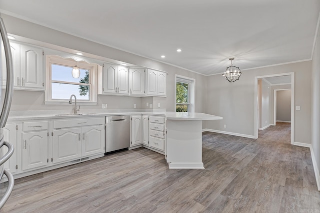 kitchen featuring white cabinetry, sink, dishwasher, a healthy amount of sunlight, and kitchen peninsula