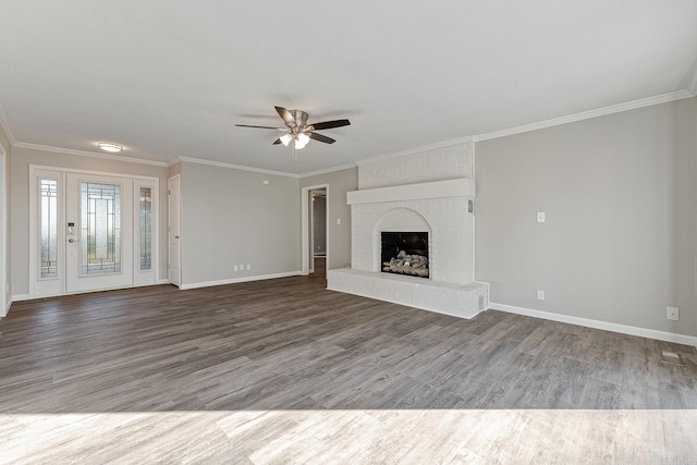 unfurnished living room featuring ceiling fan, crown molding, wood-type flooring, and a brick fireplace