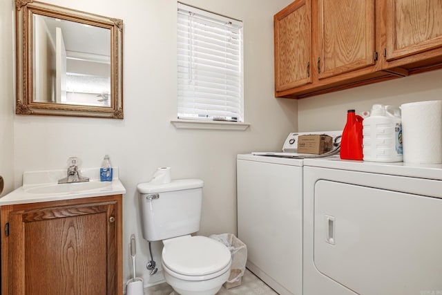 bathroom with vanity, toilet, and separate washer and dryer