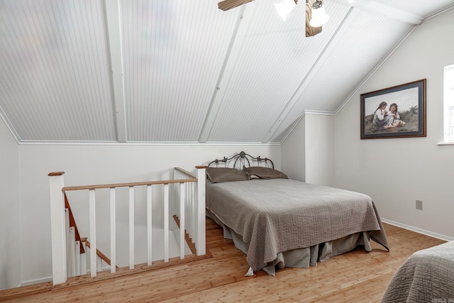 bedroom featuring vaulted ceiling, light hardwood / wood-style flooring, ceiling fan, and crown molding