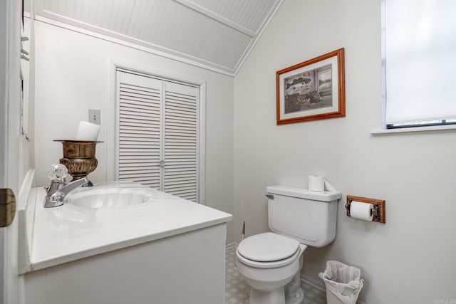 bathroom featuring crown molding, vanity, vaulted ceiling, and toilet