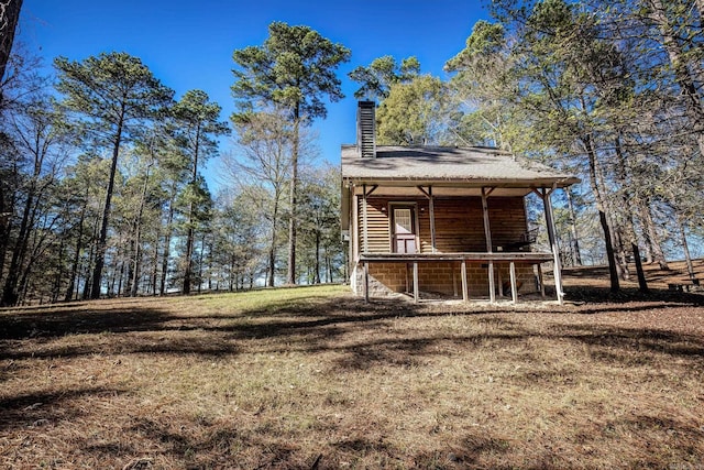 exterior space featuring a lawn and a porch