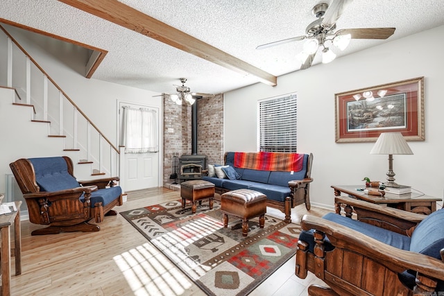 living room with beamed ceiling, ceiling fan, and light hardwood / wood-style flooring