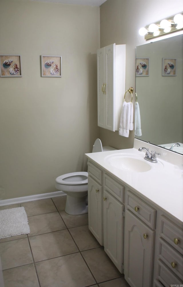 bathroom featuring tile patterned flooring, vanity, and toilet