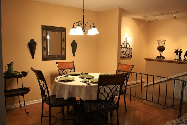 dining area featuring a chandelier and dark hardwood / wood-style flooring